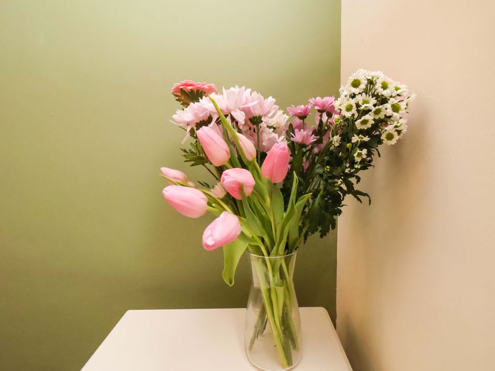 A vase with flowers on a table at Wellington Lodge Bridlington