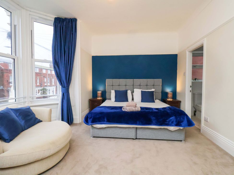 A bedroom with a bed and a sofa at Wellington Lodge in Bridlington