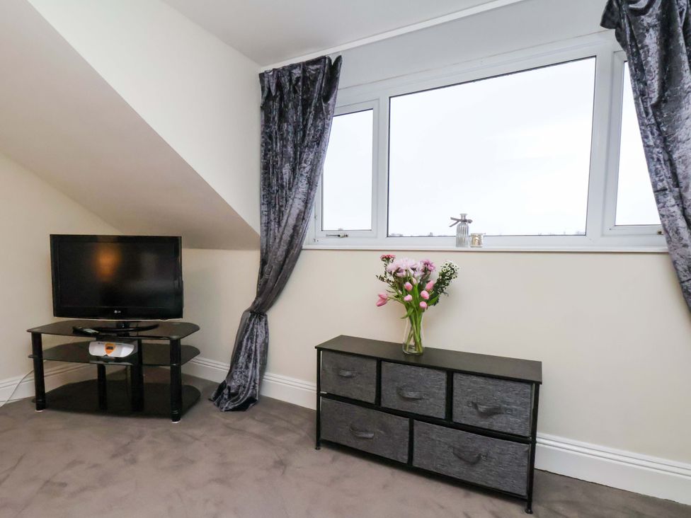 A bedroom with a TV and a dresser at Wellington Lodge in Bridlington