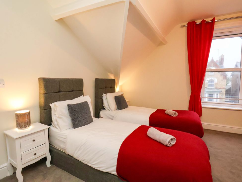 A bedroom with two single beds and a bedside table at Wellington Lodge in Bridlington
