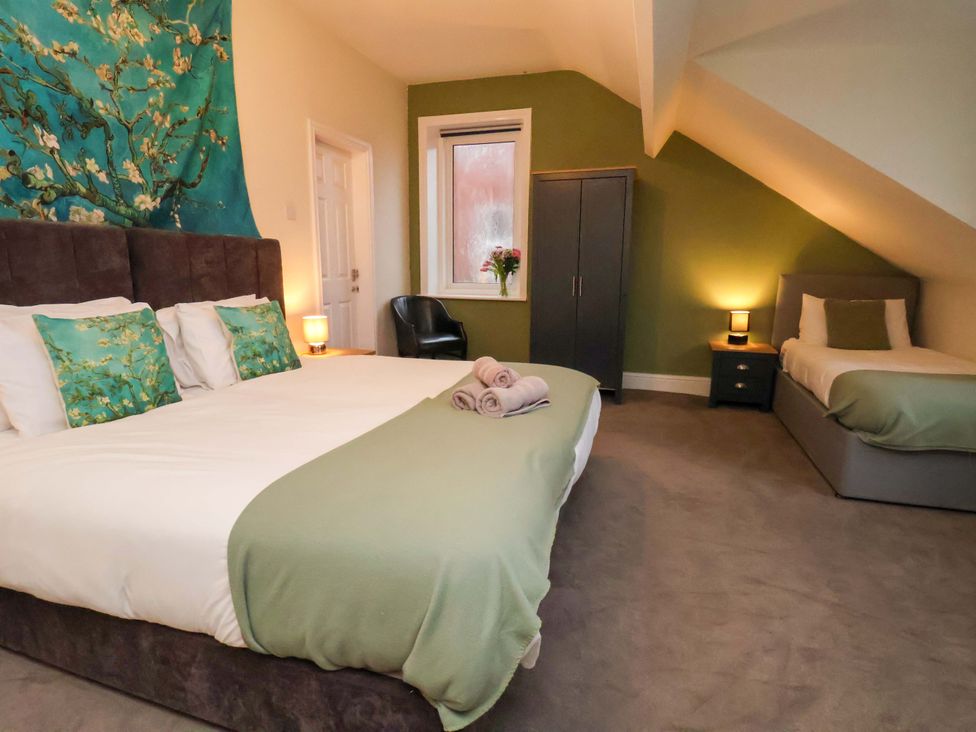 A bedroom with a bed and a single bed at Wellington Lodge in Bridlington