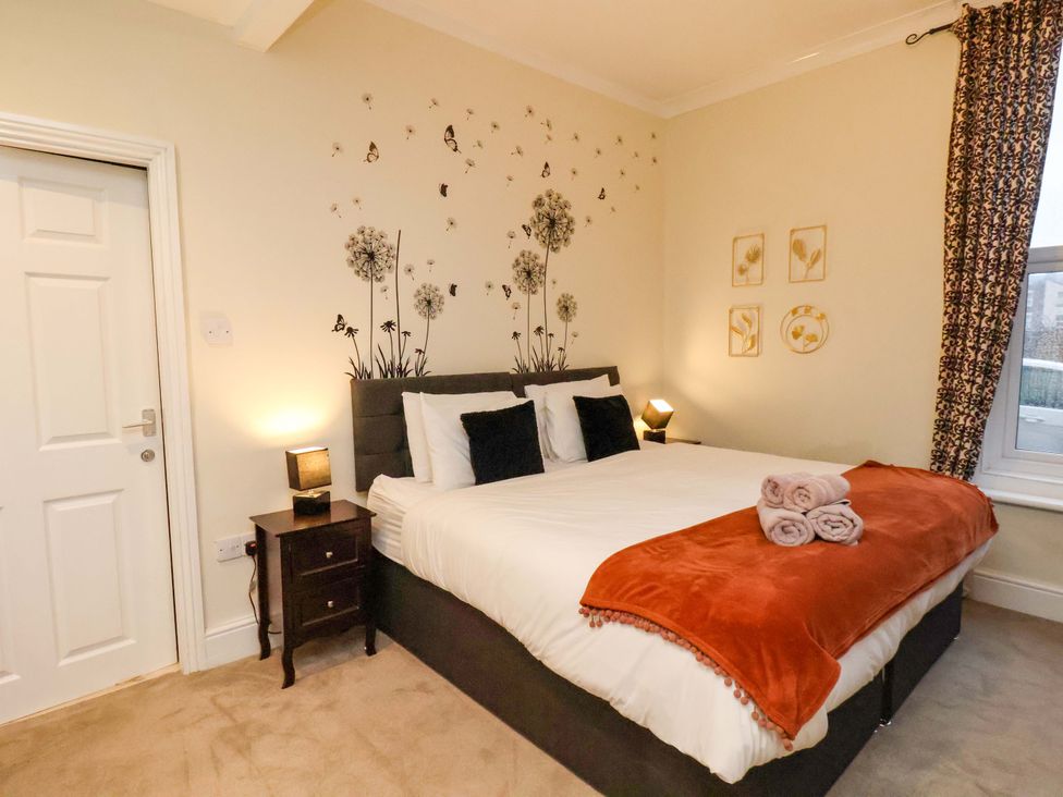 A bedroom with a bed and nightstand at Wellington Lodge in Bridlington