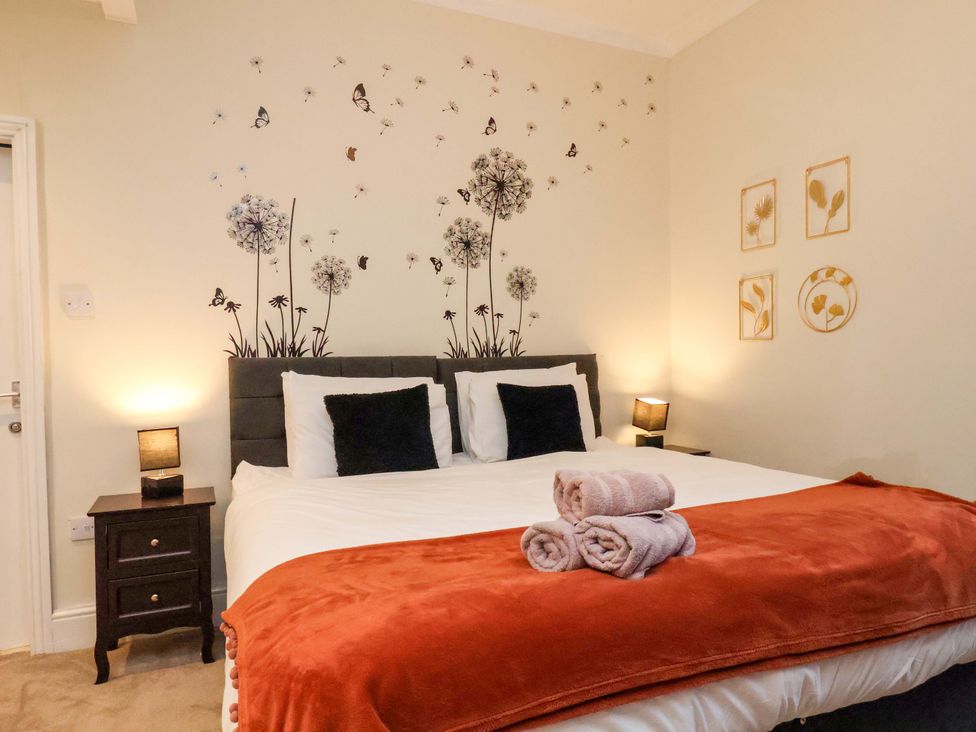 A bedroom with a bed and decor at Wellington Lodge in Bridlington