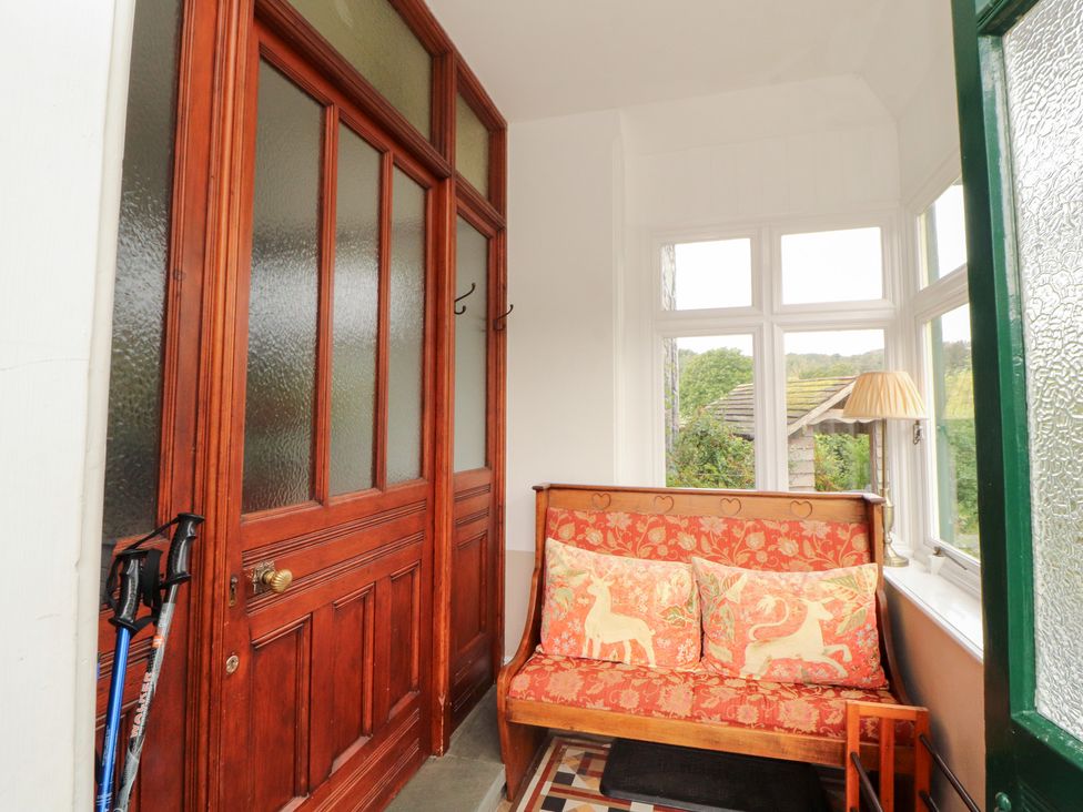 An entryway with a couch and door at Bracken Howe in Ambleside