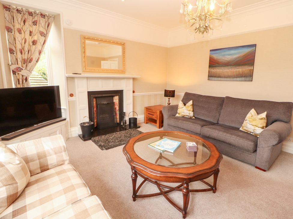 A living room with a sofa and coffee table at Bracken Howe in Ambleside