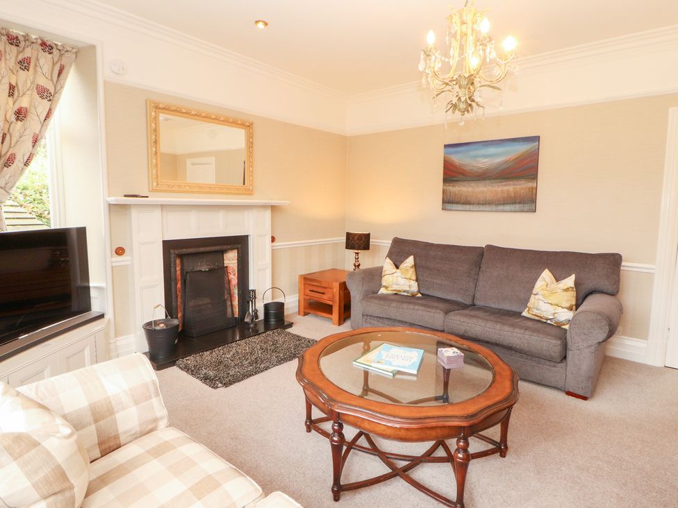 A living room with a coffee table and sofa at Bracken Howe in Ambleside