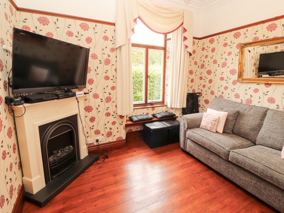 A living room with a television and a sofa at Bracken Howe in Ambleside