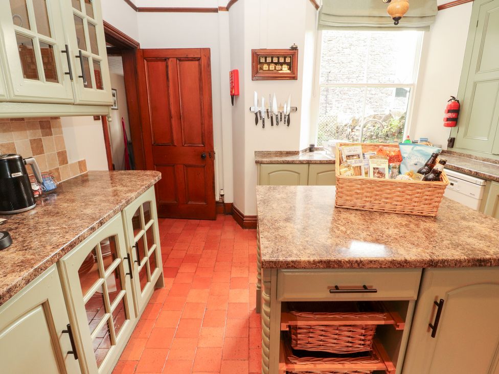 A kitchen with cabinets and island at Bracken Howe in Ambleside