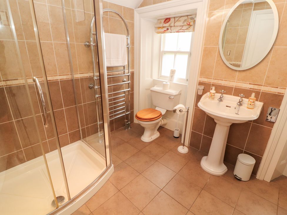 A bathroom with a shower, toilet, and sink at Bracken Howe Ambleside