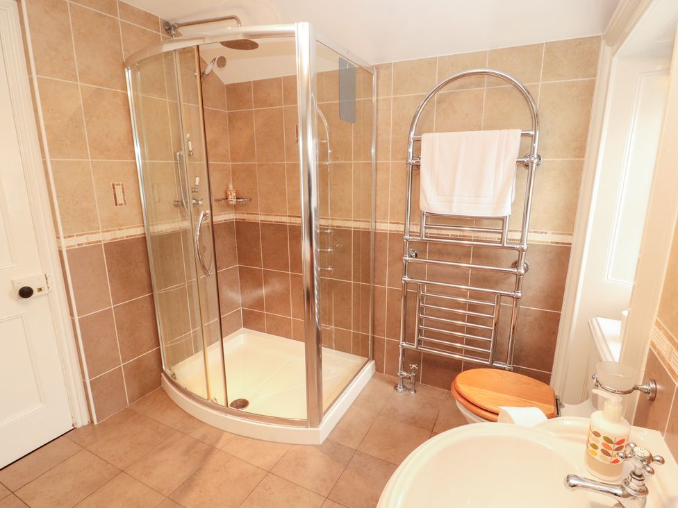 A bathroom with a shower, toilet, and sink at Bracken Howe in Ambleside