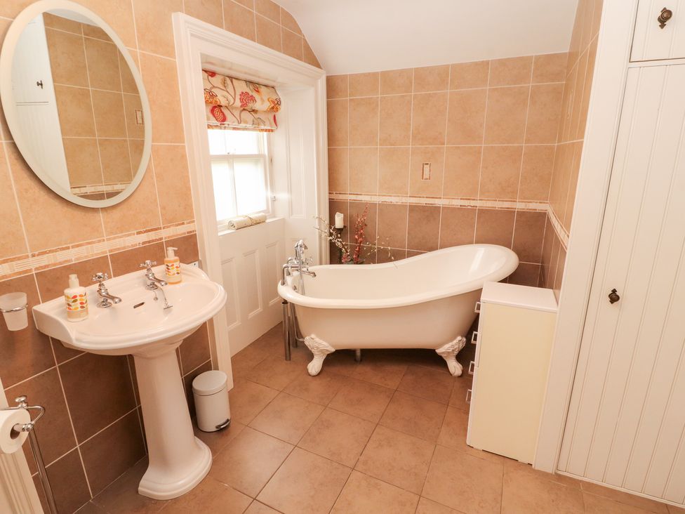 A bathroom with a bathtub and sink at Bracken Howe in Ambleside