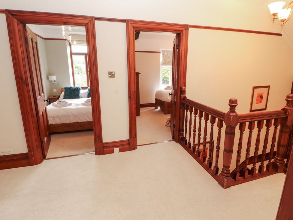 A hallway with doors leading to bedrooms at Bracken Howe in Ambleside