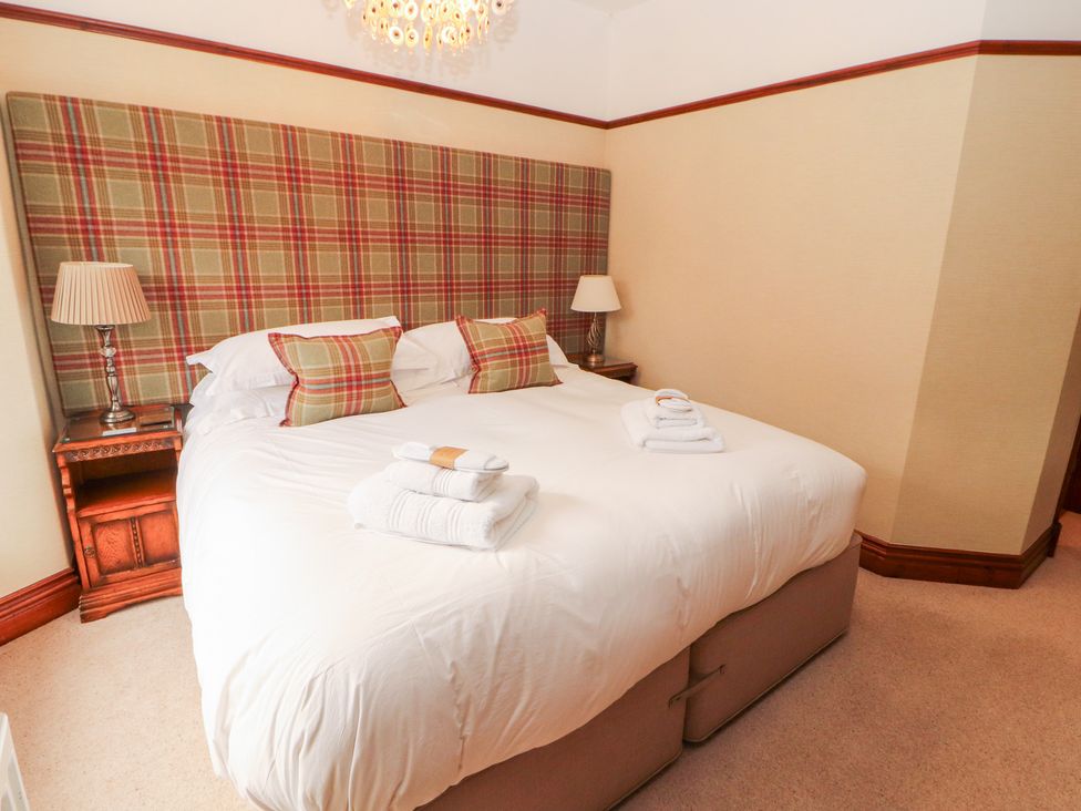 A bedroom with a bed and bedside table at Bracken Howe in Ambleside