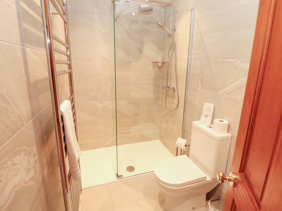 A bathroom with a shower and toilet at Bracken Howe Ambleside