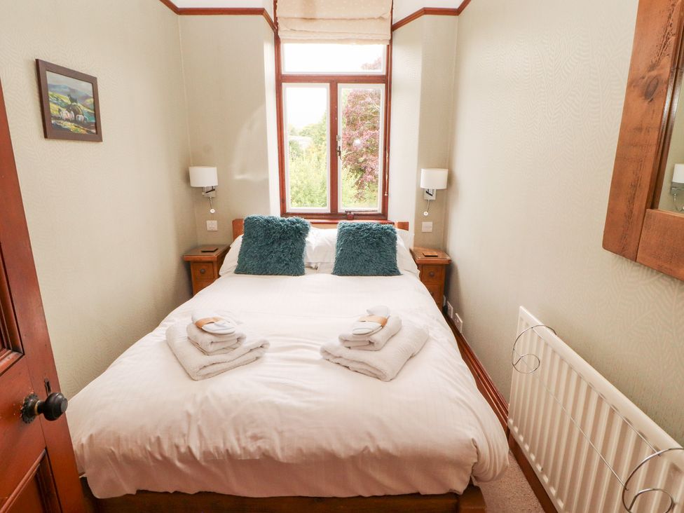 A bedroom with a bed and towels on top at Bracken Howe Ambleside