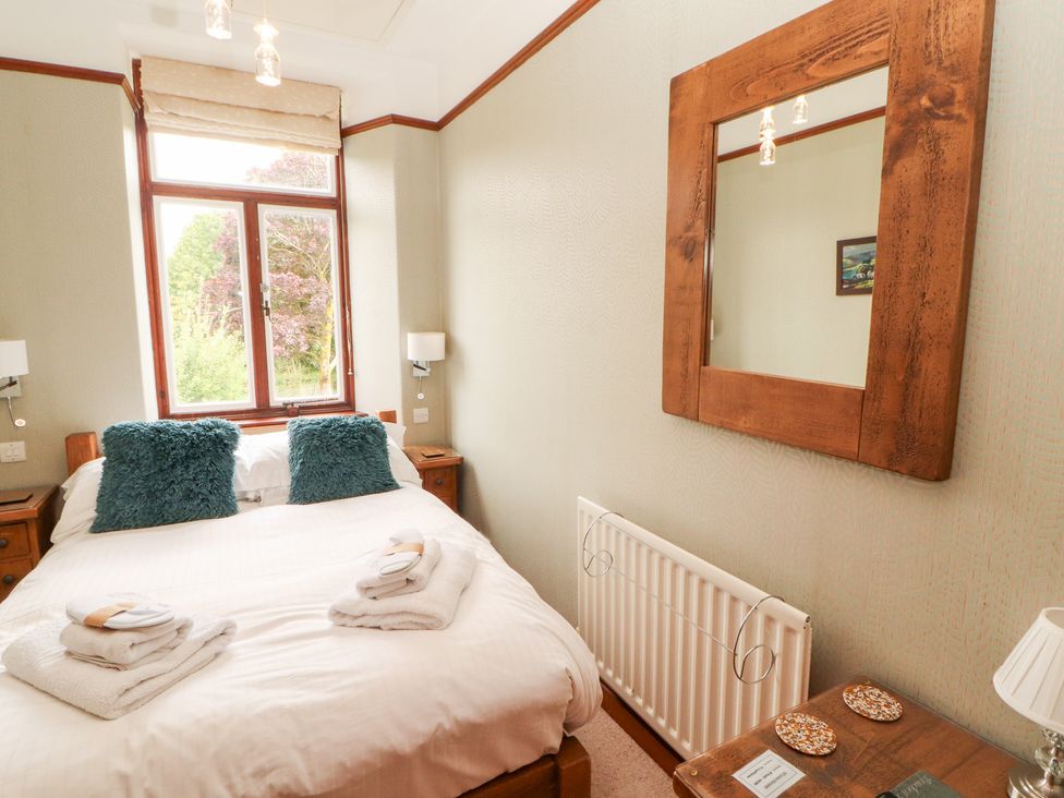 A bedroom with a double bed and bedside tables at Bracken Howe in Ambleside