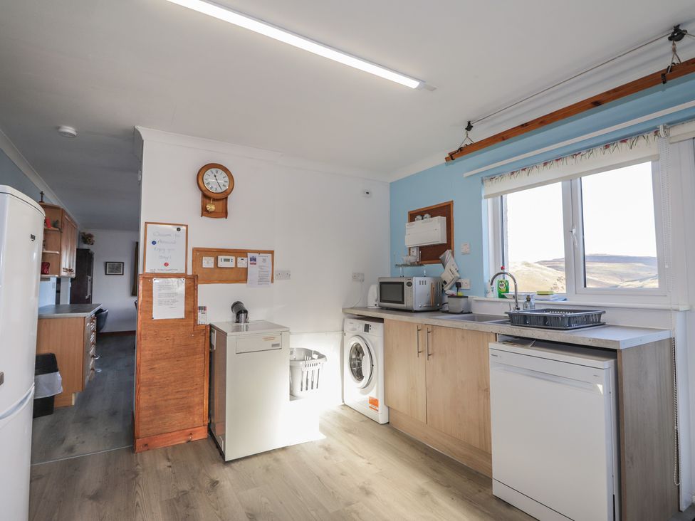 A kitchen featuring appliances and a window view at Arnaval in Carbost