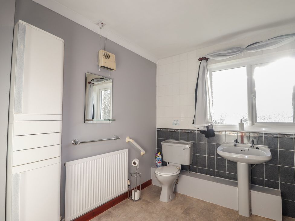 A bathroom with a sink and toilet at Arnaval in Carbost