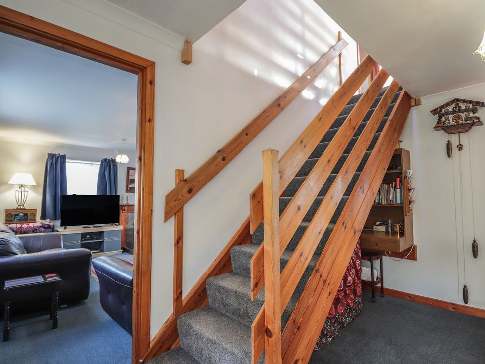 A staircase leading to an upper level in a living room at Arnaval in Carbost