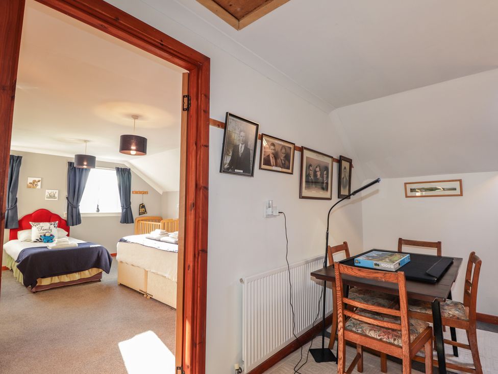 A bedroom with a bed and dining table at Arnaval in Carbost