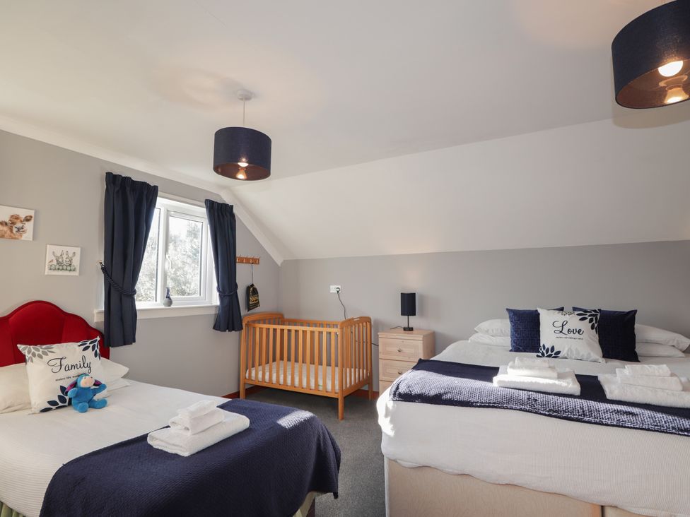 A bedroom with a bed and a crib at Arnaval in Carbost