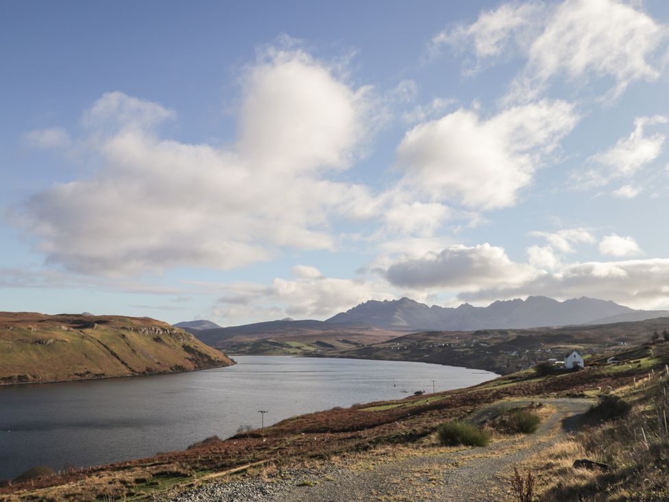 A scenic view of a lake with mountains in the background at Arnaval in Carbost