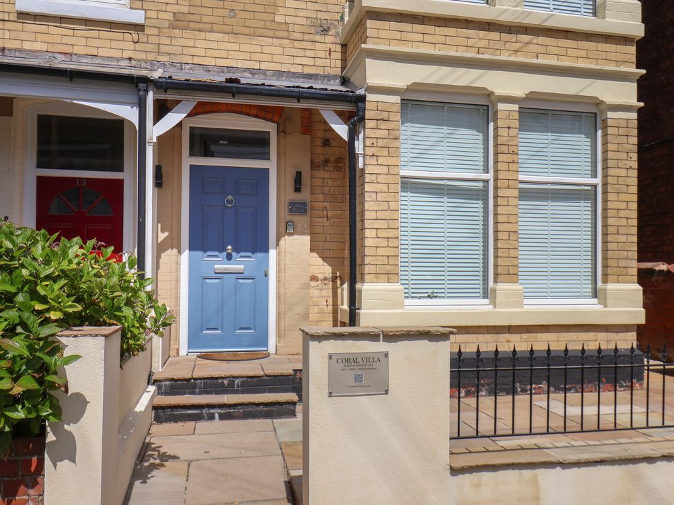 A house exterior with blue door and red door at Coral Villa in Bridlington