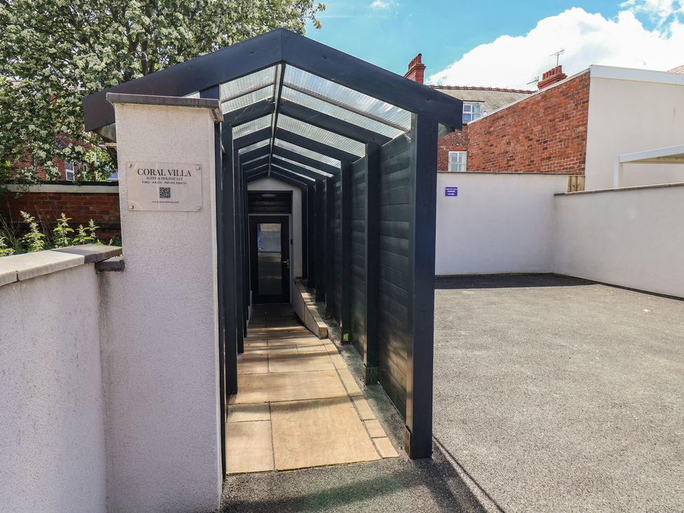 An outdoor pathway with canopy leading to Coral Villa in Bridlington