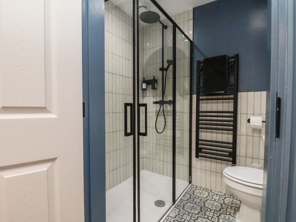 A bathroom with shower and toilet at Coral Villa in Bridlington