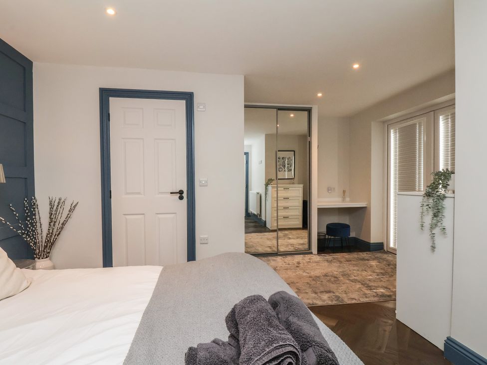 A bedroom with a bed and a desk at Coral Villa in Bridlington