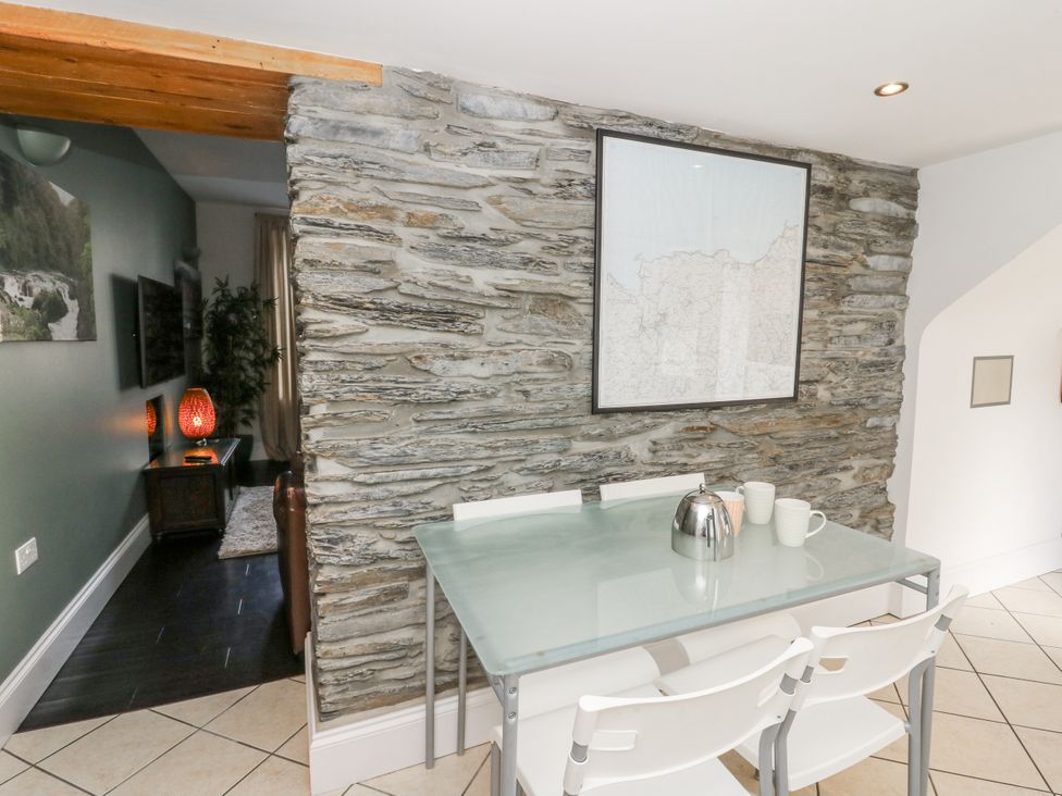 A dining room with a table and chairs at Station Hall in Cilgerran