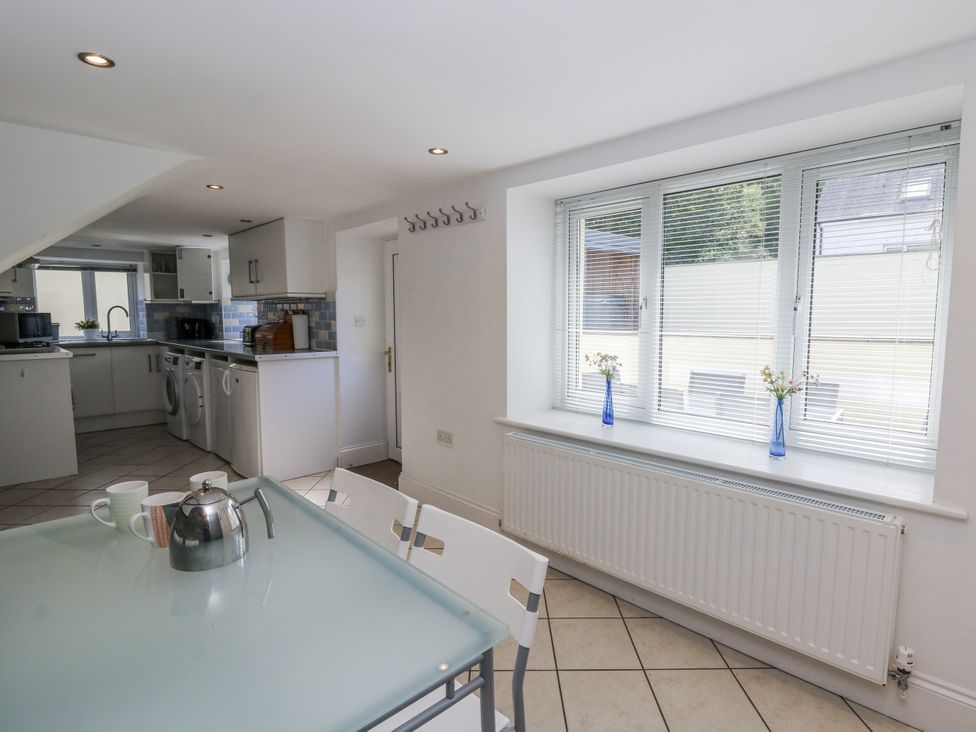 A kitchen with a table and kettle at Station Hall in Cilgerran
