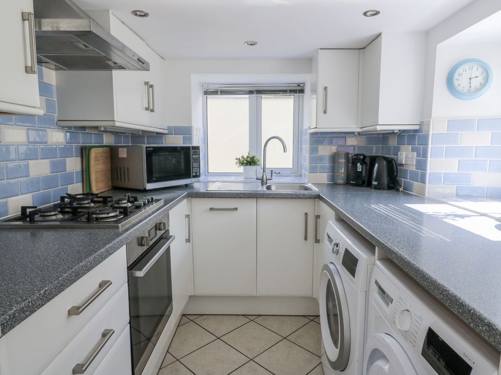 A kitchen with appliances and cabinetry at Station Hall in Cilgerran
