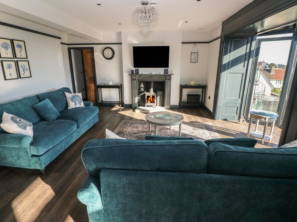 A living room with a sofa and coffee table at 9 Brython Place Tenby