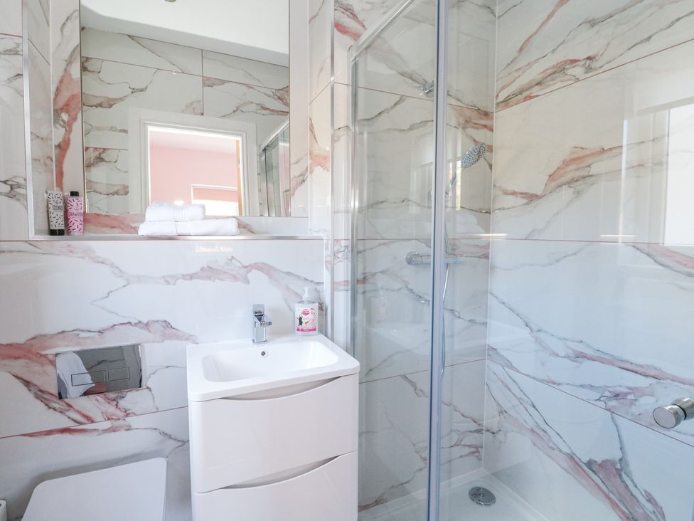 A bathroom with a sink and a shower enclosed in glass at Macgregor Ranch in Achnabobane near Spean Bridge