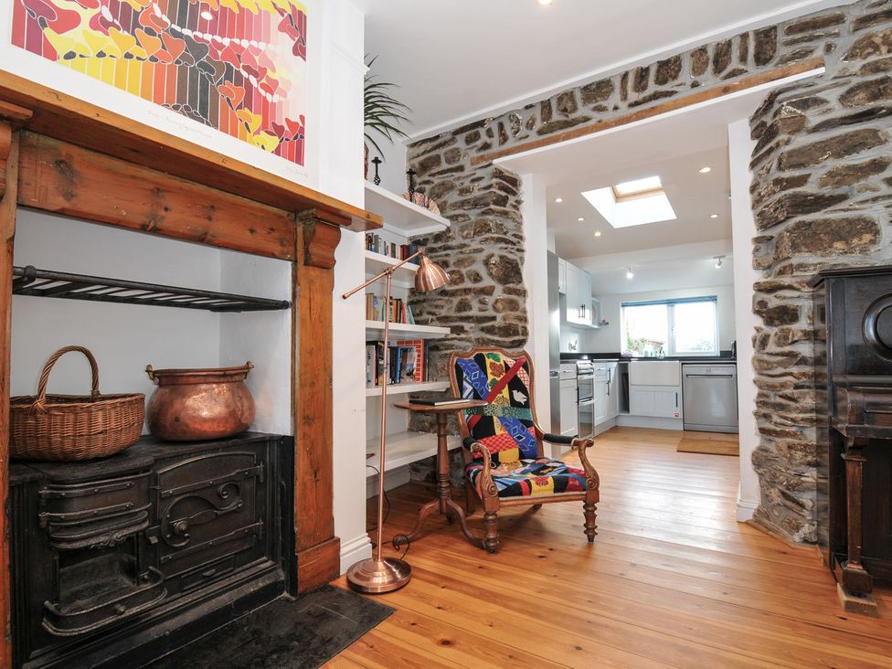 A living room with a fireplace and shelves at 2 Glyddins 1910 in Rock