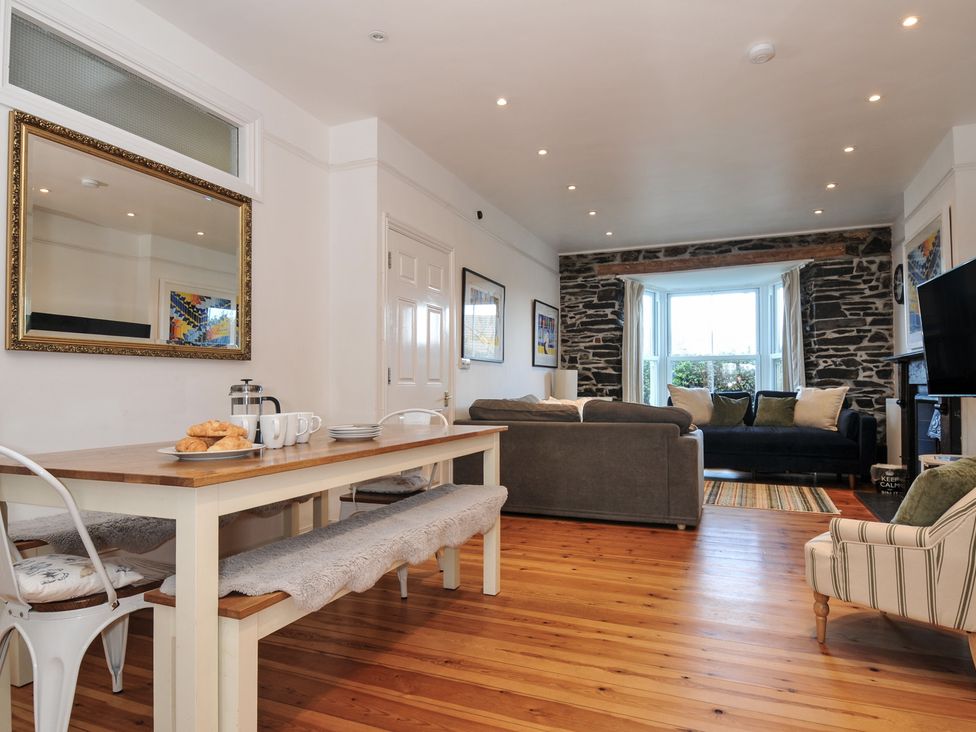 A dining area and living room with seating and a TV at 2 Glyddins 1910 in Rock