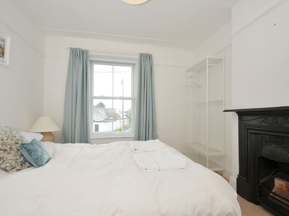 A bedroom with a bed and wardrobe at 2 Glyddins 1910 Rock