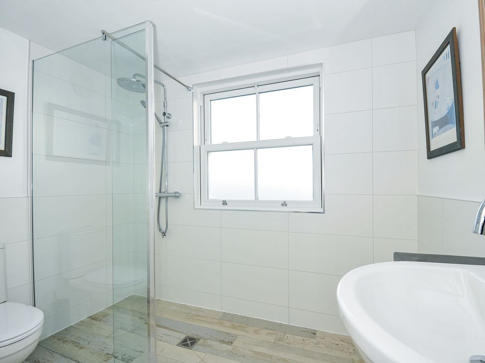 A bathroom with a shower, toilet, and sink at 2 Glyddins 1910 in Rock
