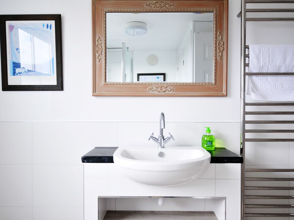 A bathroom with a sink and mirror at 2 Glyddins 1910 in Rock