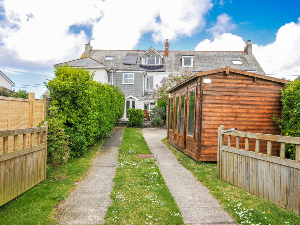 A garden pathway leading to a house with a wooden shed at 2 Glyddins 1910 Rock