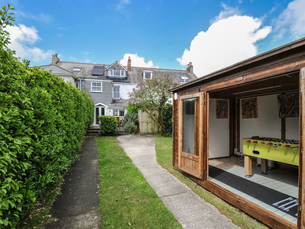 A backyard with a shed containing a foosball table at 2 Glyddins 1910 Rock