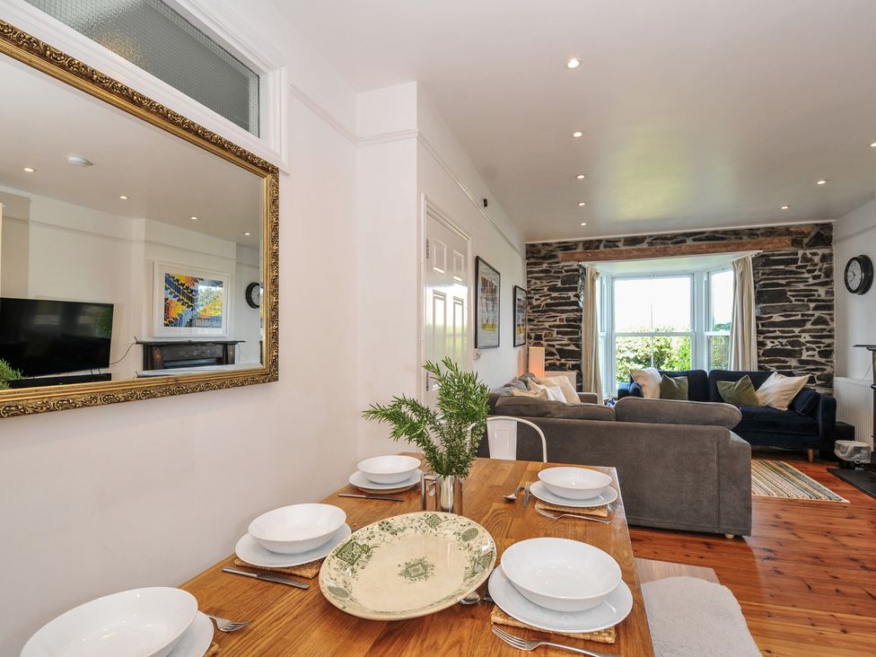 A dining area with a table set for dinner and a sitting area at 2 Glyddins 1910 in Rock