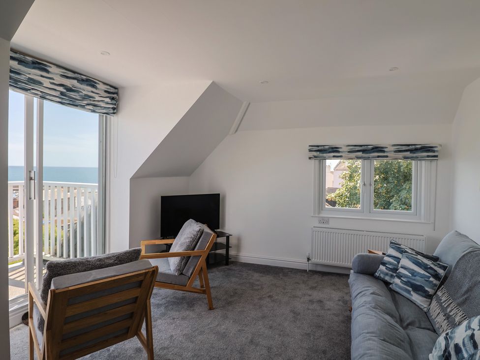 A living room with a sofa and armchair at 3 Harbour Heights Lyme Regis
