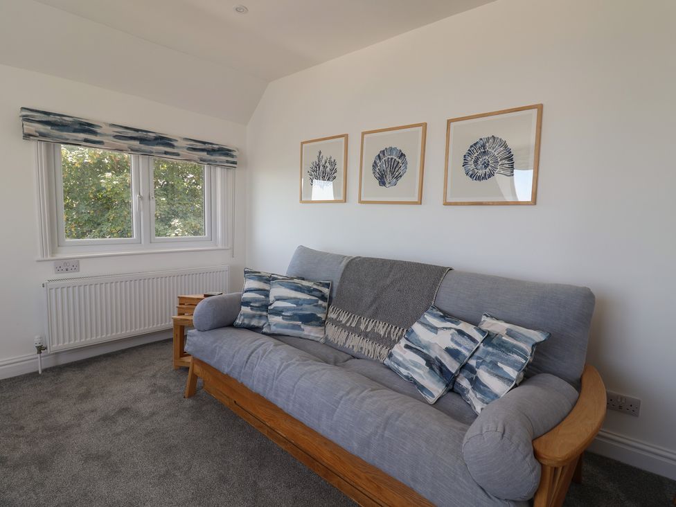 A living room with a sofa and pictures on the wall at 3 Harbour Heights Lyme Regis