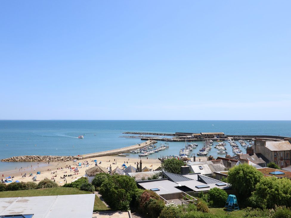A view of the beach and harbor at 3 Harbour Heights in Lyme Regis