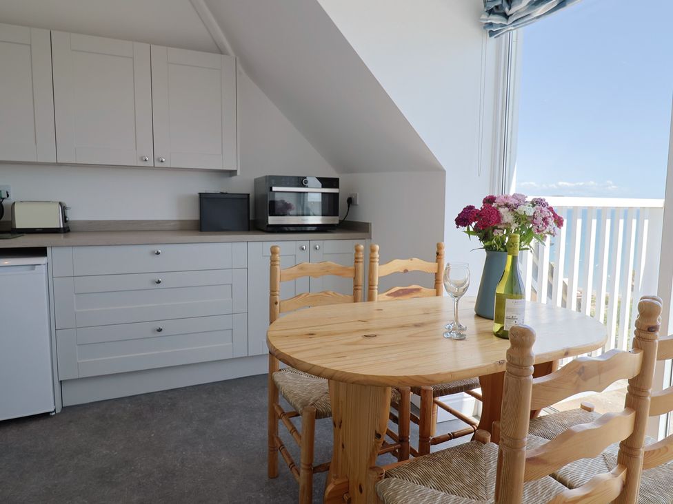 A kitchen with a table and chairs at 3 Harbour Heights in Lyme Regis