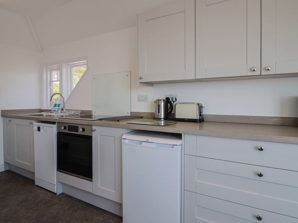 A kitchen with cabinets and appliances at 3 Harbour Heights Lyme Regis