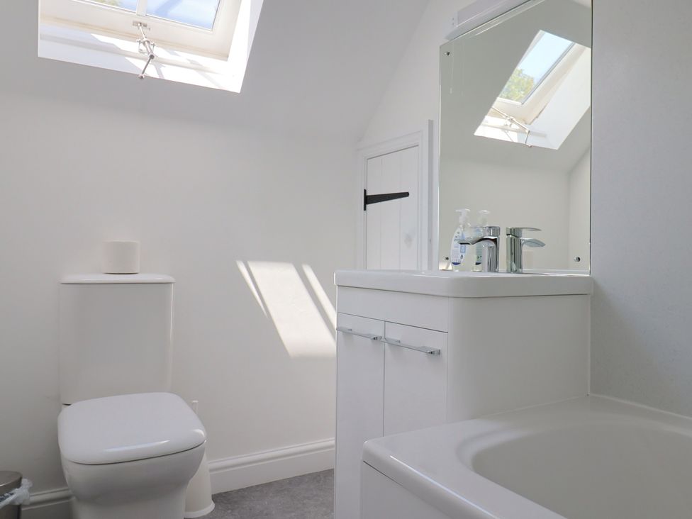 A bathroom with a sink, toilet, and bathtub at 3 Harbour Heights in Lyme Regis