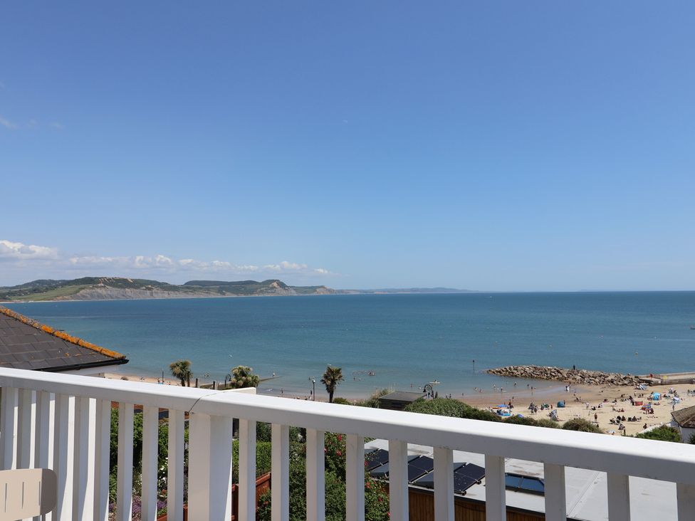 A view of the sea and beach from a balcony at 3 Harbour Heights in Lyme Regis